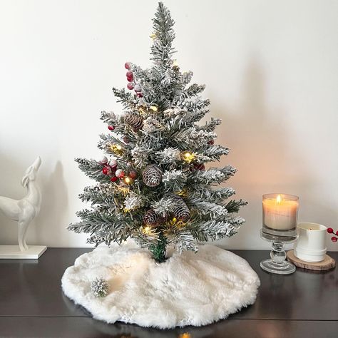 PRICES MAY VARY. CREATING WINTER WONDERLAND: Each small Christmas tree includes a mini Christmas tree skirt (15 in) of snow white faux fur, adding an extra touch of soft. As our gift to you, this mini tree skirt can even be used under other mini trees you may have. BATTERY-POWERED CONVENIENCE: The lights on this mini Christmas tree are battery-powered, requiring just 3 AA batteries (not included), so you can place your tree anywhere without the hassle of cords or outlets. PERFECTLY SIZED: Standi White Mini Christmas Tree Ideas, Small Christmas Trees On Table, Mini Flocked Christmas Tree, Mini Christmas Tree Decor, Alpine Christmas Tree, Mini Tree Skirt, Winter Core, Desktop Christmas Tree, Christmas Tree Artificial