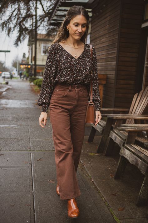 black and brown outfit with a black floral blouse, brown cropped pants, and polished camel boots Brown Button Down Shirt Outfit, Chocolate Brown Pants Outfit, Tan And Black Outfit, Brown Blouse Outfit, Brown And Black Outfit, Black And Brown Outfit, Black Top Outfit, Black Shirt Outfits, Brown Pants Outfit