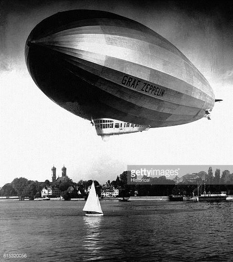 The Graf Zeppelin flies low near a sailboat on a lake in Germany Art Graf, Dieselpunk Vehicles, Zeppelin Airship, Graf Zeppelin, Pompe A Essence, Passenger Aircraft, Bw Photography, Hotel Services, Ww2 Aircraft