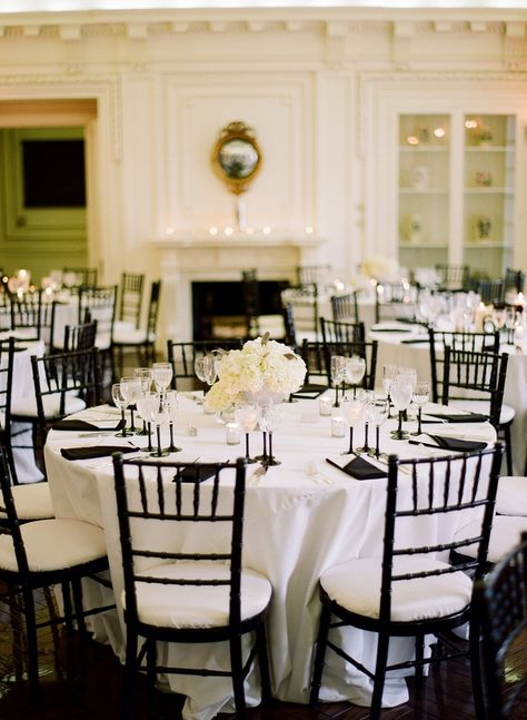 Black chairs white pads white tablecloth this has no overlay but black napkins @Lauren Palmaccio Black And White Wedding Table Linens, White Tablecloth With Black Napkins, White Linen Black Napkin Wedding, Black Chavarri Chairs Wedding, Wedding Table Black Chairs, White Tablecloth Black Runner, Black Chivari Chair, White Table Black Napkins Wedding, White Table Cloth Black Napkins Wedding