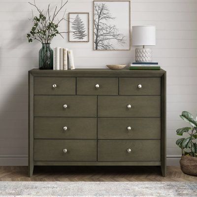 Three small and six large drawers deliver impressive storage and organization to this transitional dresser. Wood grain details add subtle texture, while drawer fronts are simply accented with gleaming silver-toned round knobs to ensure a versatile look and feel. Color: Gray | Red Barrel Studio® Joseph 9-drawer Dresser 38.5 H x 55.5 W x 16.5 D in brownWood in Gray | 38.5" H X 55.5" W X 16.5" D | Wayfair Dresser Room, Transitional Dresser, Dresser Brown, Dresser Wood, Green Dresser, 9 Drawer Dresser, Studio Color, Bedroom Dressers, Dressers And Chests