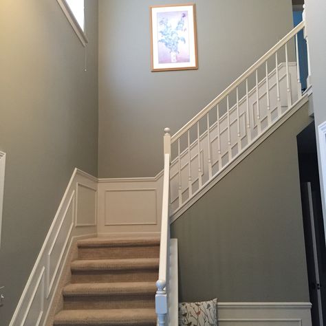 Benjamin Moore River Reflections updates a sage green foyer. Sage Green Foyer, Sage Green And White Hallway, Sage Green Panelling Hallway, Sage Green Stairs, Sage Green Staircase, Sage Green Hallway And Stairs, Sage Hallway Ideas, Pale Green Hallway, River Reflections Benjamin Moore