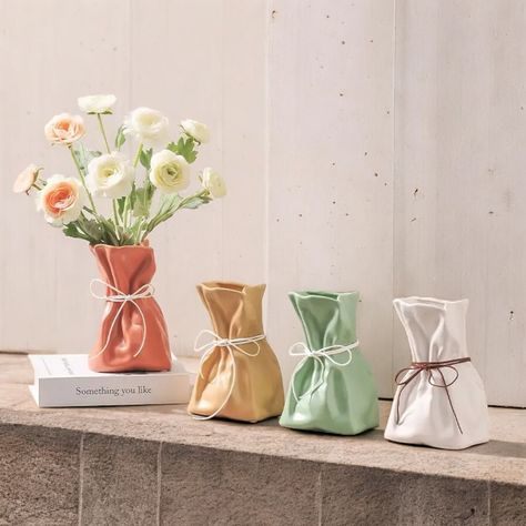 ৹ Height - 18.5cm/7.28 Inch | Width - 12.5cm/4.92 Inch Introducing the Paper Bag Vase! 🌟 This unique ceramic bag-shaped flower pot is the perfect addition to your home decor. 🏡 Imagine adding a touch of whimsy and color to any room with this cute and colorful decorative vase. 🌈 Crafted to resemble a charming paper bag, it brings a playful yet stylish element to your decor. 🎨 Ideal for displaying your favorite flowers or as a standalone piece. 🌸 Picture this adorable vase as the centerpiece of your home, sparking joy and conversation among your guests. 💬 Its unique design and vibrant colors make it a standout piece that complements any decor style. 🏆 Perfect for those who love to combine creativity with elegance in their living spaces. 🌺 Don't miss out on the Paper Bag Vase! 🛒 Orde Purse Vase, Advertising Gifts, Vase With Lights, Decorated Flower Pots, Nordic Decor, Colorful Ceramics, Home Decor Vases, Ceramic Vases, Ceramic Planters