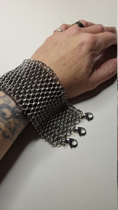 **All orders placed on or after December 3rd are not guaranteed to arrive before Christmas!! As its only me handmaking each item all available dates have been filled. I make each order in the order i receive them. My apologies for any inconvenience This is a slinky chunky dragonscale bracelet made from 100% stainless steel. Very flexible and comfortable to wear Feels cool on the skin. The pattern is a set of large rings with smaller rings going through the center of the weave. Making this weave dense. This is a heavy bracelet. Any returns will be subject to a 20% restocking fee. This portion of your payment will be non-refundable. Find more videos of my creations @dredmouse on Tiktok!    Check out my page for a 20 percent discount code! Joan Of Arc Costume, Chainmail Glove, Large Rings, Etsy Shop Branding, December 3rd, Chainmail Bracelet, Chainmail Jewelry, Woven Bracelets, Chain Mail