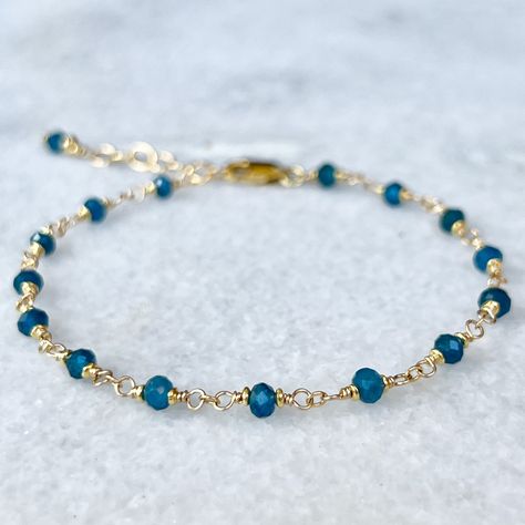 Blue apatite gemstone bracelet, hand-wrapped rosary style on 14k gold filled wire with tiny 22k gold vermeil  accent beads (gold plating over sterling silver).   Details~ *  All findings used are 14k gold filled, made to last for years to come.  * Length: Bracelets are finished with an extender chain, making them adjustable in length. I offer two size options: Sm. 6 1/2 - 7 1/2 inches or Med. 7 1/2 - 8 1/2 inches * Packaging: Your order will arrive packaged in a gift box, wrapped with a ribbon and ready for gifting. * Please visit my Etsy shop for a full selection of my handmade jewelry: https://www.etsy.com/shop/beadedgemsbycristina * Thanks so much for stopping by my shop and please let me know if you have any other questions, I am here and happy to help! Birthstone Beaded Bracelets, Blue Gemstone Bracelet, Chain Making, Handmade Jewelry Tutorials, Beads Bracelet Design, Gold And Blue, Handmade Beaded Jewelry, Handmade Wire Jewelry, Blue Apatite