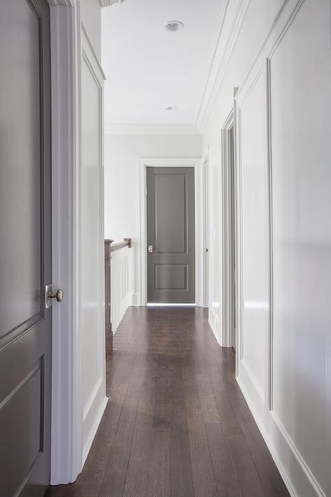 Chic hallway features white walls fitted with gray paneled doors adorned with polished nickel door ... Hallway Colors, Interior Door Paint Colors, Interior Door Colors, Cottage Getaway, Grey Interior Doors, White Hallway, Painted Interior Doors, Greige Design, Door Paint