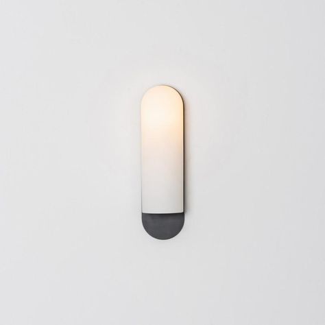 Odyssey lg sconce by schwung dimensions: w 10.5 x d 14 x h 38 cm materials: brass, frosted glass finishes available: black gunmetal, polished nickel, brass schwung is a german word, and loosely defined, means energy or momentumm of a positive manner. Synonyms: verve, zest, panache, momentum. Mission developing lighting fixtures through simple and timeless materials, sustainably; we are committed to creating quality products that last. Beginning with the design we are constantly refining aestheti German Word, Black Sconces, Black Wall Lights, Modern Baths, Lighting Design Interior, Modern Sconces, Wild Rice, Black Wall, Light Sconces