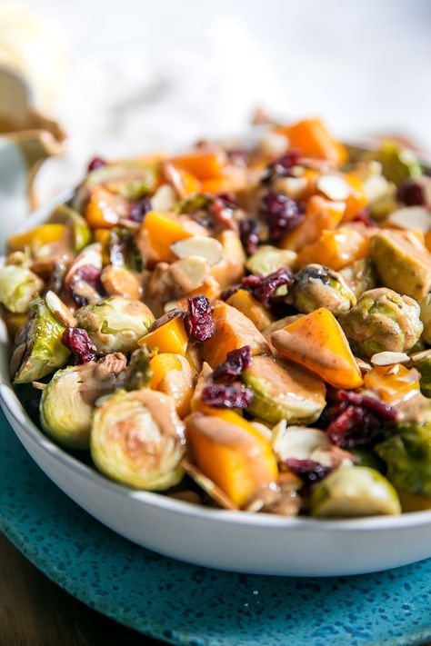 A fun and festive Maple Roasted Brussels Sprouts and Squash recipe gets tossed in an Almond Butter Balsamic Dressing. It's the perfect, healthy side dish for your next holiday gathering that will not disappoint! Serve it at your next Thanksgiving dinner for all to enjoy. Vegan, Gluten-Free, and Paleo Friendly, too! Maple Brussel Sprouts, Thanksgiving Favorites, Maple Sweet Potatoes, Sweet Potato Pecan, Fall Menu, Squash Recipe, Roasted Brussels Sprouts, Balsamic Dressing, Acorn Squash