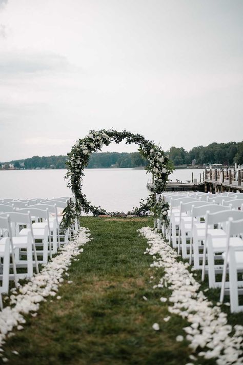 This Summer Lake wedding was intimate and romantic. Elements of the lake were on the custom stationery, as well as the details of the wedding. Neutral florals made for a bright and beautiful waterfront ceremony area that was the highlight of their wedding day. See more from this lake wedding at https://annahowedesign.com/tiffany-connor/ Outdoor Waterfront Wedding, Lake Wedding Backdrop, Wedding By The Lake Outdoor Ceremony, Garden Lake Wedding, By The Lake Wedding, Outdoor Pond Wedding Ceremony, Weddings By The Lake, Wedding On A Lake Ideas, Riverfront Wedding Ceremony