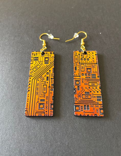 These stunning STEM inspired acrylic earrings are sure to be your favorite pair! An array of circuits decorate these rectangular shaped dangle earrings. The earrings are very lightweight and airy, so they are comfortable to wear all day! The perfect gift for your favorite engineer or STEM professional. Available in several colors - sunset iridescent that shifts from orange to green, or the subtle sparkle silver. Details: * Designed and created by Elishka Jepson * Available colors:    - Sunset ir Cyberpunk Accessories, Circuit Board Design, Nerd Crafts, Tech Jewelry, Acrylic Jewelry, Funky Earrings, Recycled Jewelry, Clay Jewelry Diy, Acrylic Jewellery