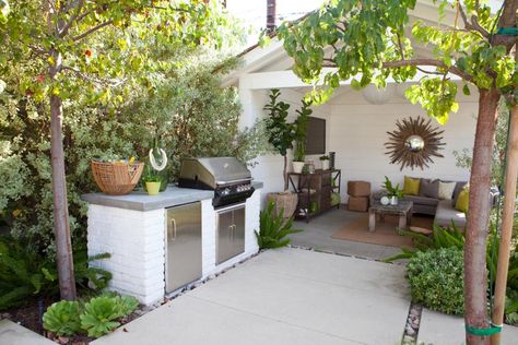 White brick and a concrete countertop make up the outdoor grilling station of this patio. Lush landscape offers plenty of privacy and shade. Grilling Station, Cottage Patio, Patio Images, Brick Bbq, Outdoor Grill Station, Patio Grill, Outdoor Kitchen Countertops, Grill Station, Outdoor Bbq Kitchen