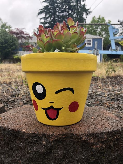 Hand painted flower pot. Acrylic Paint. Pokémon flower pot. DIY. Easy painted flower pot. Pikachu. Painting ideas. Terra cotta pots. Kids Painting Flower Pots, Pot Plant Painting Ideas Easy, Painting Ideas On Pots Easy, Mario Flower Pot, Pokemon Flower Pot, Cute Flower Pot Painting Ideas Easy, Easy Pot Painting Designs, Flower Pot Painting Ideas For Kids, Painted Flower Pots Easy