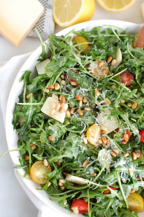 Lemon Arugula Salad with Pine Nuts is a quick and easy salad that is peppery, sweet and satisfying. Arugula is tossed with cherry tomatoes, toasted pine nuts and parmesan cheese and finished off with a lemony, olive oil dressing. // acedarspoon.com #salad #vegetarian Salad Recipes Spring, Lemon Arugula Salad, Recipes Fancy, Veggie Hummus Wrap, Pine Nuts Salad, Recipes With Parmesan Cheese, Salad Vegetarian, Keto Salads, Arugula Salad Recipes