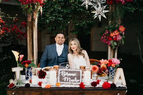 Mexican Wedding  - with a boho twist - Bride & Groom cheers sweetheart table  - at Rancho Buena Vista Adobe Bride And Groom Table Mexican, Mexican Sweetheart Table, Sayulita Wedding, Mexican Themed Weddings, Hacienda Wedding, Sweetheart Table Wedding, Boho Twists, Spanish Wedding, Modern Mexican