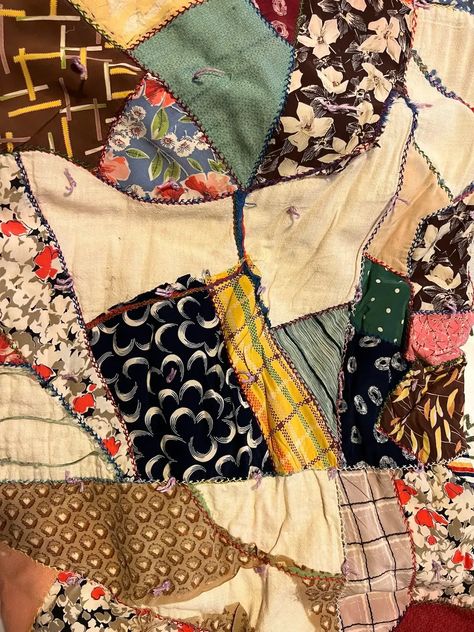 Close up of another vintage crazy quilt made from silks; Crazy quilts have asymmetrical designs, vibrant colors, and intricate stitching patterns. Originating in the late 19th century as a rebellion against the rigid rules of traditional quilting, this unique art form allows quilters to unleash their imagination and showcase their individuality through a patchwork of fabrics. How To Sew A Crazy Quilt, Vintage Crazy Quilts, Crazy Quilt Patterns Free, Crazy Quilt Ideas, Crazy Quilts Ideas, Scrappy Patchwork Quilts, Crazy Quilt Patterns, Unique Quilt Patterns, Crazy Quilt Templates