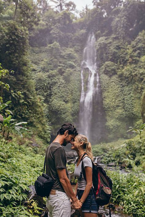 Plus 6 tips of things to do while traveling together. Things To Do While Traveling, Couple Standing Together, Waterfall In Forest, Bali Travel Photography, Waterfall Forest, Traveling Together, Travel Pose, Looking At Each Other, Travel Pictures Poses