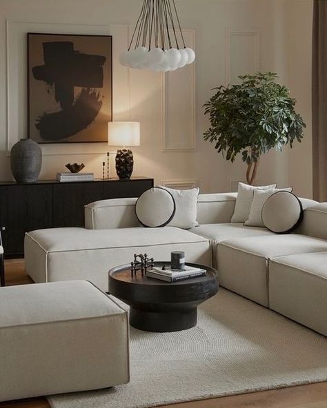 Cream And Black Sofa, Brown Black And White Living Room Minimalist, Beige Sofa Black Coffee Table, Beige Interior With Black Details, Beige Couch With Black Coffee Table, White Sofa Black Coffee Table, Cream Sofa Black Coffee Table, Living Room Decor With Black Accents, Black And Cream House Decor