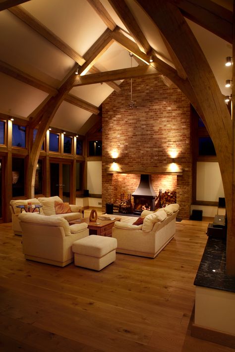 Surface mounted spotlights provide direct lighting to the central area of this living room.  The same design provides a peripheral light by reflecting back from the oak frame.  Up and down lighting on the chimney breast highlights the texture of the bricks. Barn House Conversion, Barn Conversion Interiors, Vaulted Ceiling Ideas, Oak Framed Extensions, Vaulted Ceiling Lighting, Scandinavian Design Living Room, Coastal Dining, Barn Living, Down Lighting