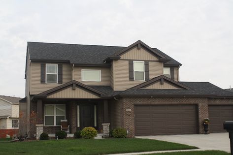 Dark roof, Pebblestone Clay siding, Dark brown trim, and decorative gable accents, pebblestone clay vertical siding in Normal IL Pebblestone Clay Siding, Siding With Brown Trim, Clay Siding House Exterior Colors, Dark Brown House Exterior Ideas, Dark Brown Roof House Colors, Dark Brown House Exterior, Brown Home Exterior, Brown Trim House Exterior, Brown Exterior House Colors