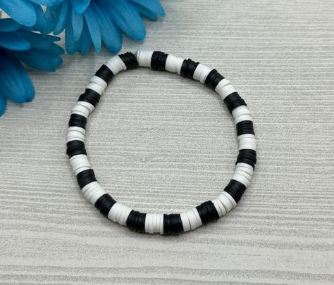 Select a bracelet length. This bracelet comes as stretch / elastic only (no clasp). Beads include: 6x1mm clay disc bead (heishi beads) in black and white Bracelet is handmade and new. Please realize that the bracelet may vary slightly from the one pictured based on the different lengths and / or clasps chosen. Please see sizing details in shop FAQ.  Is this a gift? Don't know their bracelet length? The average bracelet length for teens is 6.5 inches.  The average bracelet length for women is 7.0 Black And White Clay Bracelet, Clay Bead Bracelet Ideas Black And White, Black And White Bracelet Pattern, Black And White Clay Bead Bracelet, Black Clay Bead Bracelet, 🧿 Bracelet, Black And White Bracelets, Bracelet Heishi, Accessories Idea