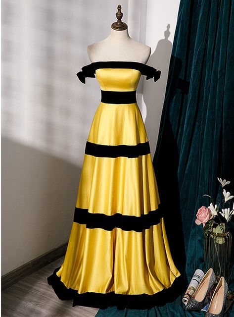 Steal the spotlight effortlessly! Designed from lustrous satin, this gown is the epitome of timeless elegance with its vibrant yellow hue contrasted by bold black bands. The off-shoulder silhouette exudes an air of old-world charm, while the structured tiered design adds depth and dimension. The gown is completed with a subtle back zipper, making dressing up a breeze. Party Dress Inspiration, Yellow Striped Dress, Bee Dress, Prom Dresses Yellow, Exquisite Gowns, Satin Evening Dresses, Yellow Satin, Dresses 2023, Birthday Party Dress