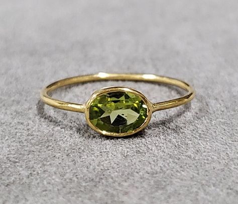 1. 14k Gold Peridot Ring 2. Made to Order 3. Gemstone - Peridot 4. Jewelry Type - Gold Ring 5. Total Weight - 0.990 Gram Approx. 6. Peridot Weight - 0.70 Carats 7. Gold Weight - 0.850 Grams Approx. 8. Peridot Size - 5 x 7 MM 9. Gold Purity - 14k 10. Band Size - 1 MM 11. Handmade Items 12. AAA Quality Ring 13. Statement Ring 14. 2 Quantity Available 15. Ready to Dispatch in 1 - 2 days. 16. Shape - oval  Pictures are taken under natural and day light. Unique Peridot Ring, Handmade Gold Ring, Peridot Jewelry, Gold Statement Ring, Bezel Ring, Ringe Gold, Peridot Ring, Green Peridot, Jewelry Lookbook