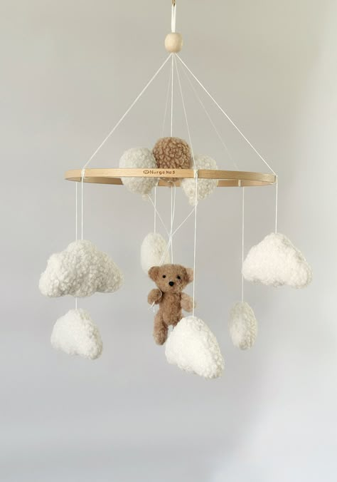 Mobile Teddy Bear boucle Clouds Boucle Neutral gender mobile Nursery decor boucle Pregnancy gift Clouds mobile Brown bear mobile A minimalist bouclé mobile with clouds and bear with balloon is an ideal decor for a child's room for both a boy and a girl! For a child's room in any style! Made with love! 💭Materials: Korean felt American felt Hypoallergenic filler Beech wood base Boucle  💭TO ORDER If you would like to make a custom order, just message me! You can change the details of any children Teddy Bear Mobile, Teddy Bear Nursery Theme, Bear Themed Nursery, Bear Nursery Theme, Clouds Mobile, Teddy Bear With Balloons, Bear With Balloons, Brown Nursery, Bear Mobile