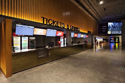 Bold, oversized, saturated colour numbers used as feature entrances to each of the cinema screens create an outstanding, contemporary visual feast, both aiding in the ease of circulation for the patrons as well as composing a juxtaposition against the raw concrete finishes. Ticket Counter Design Modern, Multiplex Cinema Design, Cinema Design Architecture, Ticket Counter Design, Cinema Entrance, Small Cinema Room, Cinema Lobby, Cinema Interior, Reception Ceiling