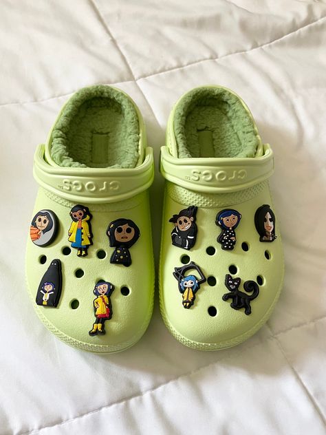 Coraline Crocs for Halloween/Spooky Season Unique Crocs Shoes, Light Green Crocs With Charms, Sage Green Crocs, Green Crocs Aesthetic, Green Crocs With Jibbitz, Croc Themes, Green Crocs With Charms, Crocs With Charms Ideas, Crocs Charm Ideas