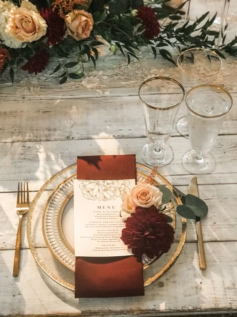 Burgundy gold and white wedding reception decoration Burgundy And Terracotta Wedding Table, Copper Table Setting Wedding, Terracotta Burgundy Gold Wedding, Burnt Orange Wedding Place Setting, Terracotta And Gold Wedding Decor, Gold Rimmed Plate Table Setting, Terrocata And Burgundy Wedding, Fall Wedding With Gold Accents, Bride And Groom Table Burgundy