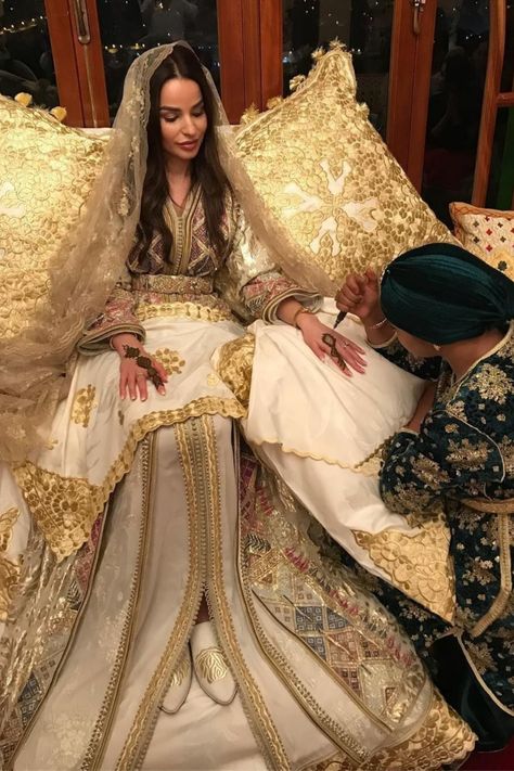 On henna night, the Moroccan bride usually wears a super creamy white or green kaftan surrounded by her family and friends . She's getting ready for her wedding night. #wedding#bride#enjoy Moroccan Henna Party, Henna Party Dress, Traditional Moroccan Wedding, Henna Day, Moroccan Wedding Theme, Moroccan Wedding Dress, Arabic Wedding Dresses, Moroccan Henna, Moroccan Bride