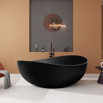 This freestanding bathtub is made of resin stone for excellent insulation, and its ergonomic curves make it ideal for long soakings, and are easy to clean and indestructible. Whether indulging in solitary moments of tranquility or sharing intimate moments with a loved one, this bathtub creates a romantic ambiance, transforming every bath into a memory of romance and affection. | HIGEINE 63“ x 37” Freestanding Soaking Solid Surface Bathtub In Black 23.6 H x 63.0 W x 37.4 D in blackSolid Surface, Black Bathtubs Master Bath, Matte Black Freestanding Tub, Large Soaking Tub For Two, Japanese Bathtub Soaking Tubs, Black Tub Bathroom Ideas, Black Bath Tub, Black Freestanding Tub, Unique Bathtubs, Corner Freestanding Bathtub