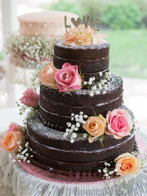 Keep it sweet and simple with a naked chocolate ganache wedding cake. Sprinkle powdered sugar onto the tiers, decorate with colorful, fresh flowers, and finish it off with a simple cake topper. Homemade Wedding Cake, Cake With Flowers, Chocolate Wedding, Torte Cupcake, Wedding Cake Photos, Homemade Wedding, Naked Cakes, Chocolate Wedding Cake, Wedding Cake Rustic