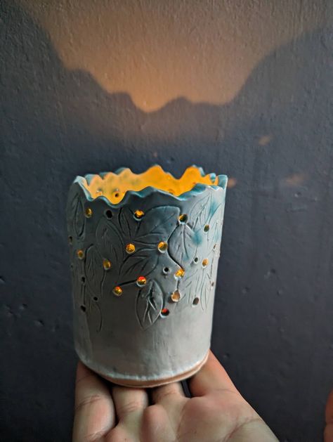 Ceramic slab work cylinder holes carved leaves Ceramic Luminary Handmade, Cylinder Ceramic Ideas, Cylinder Pottery Ideas, Ceramic Portfolio, Ceramic Luminaries, Ceramic Cylinders, Leaf Candle, Leaf Candle Holder, Clay Classes