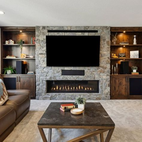 FBC Remodel | Design. Collaborate. Build Joy. on Instagram: "This Minneapolis basement is tailor-made for winter hibernation, from the warm woodwork to the cozy fireplace to the spacious bar!   #minneapolisbasementremodel #homeremodeling #basement #basementremodel #basementdesign #fbcremodel" Finished Basement Ideas With Fireplace, Fireplace Wall Basement, Fireplace In Basement Ideas, Basement Fireplace Ideas With Tv, Basement Fireplace With Tv, Modern Fireplace Decor, Winter Hibernation, House Basement, Basement Fireplace