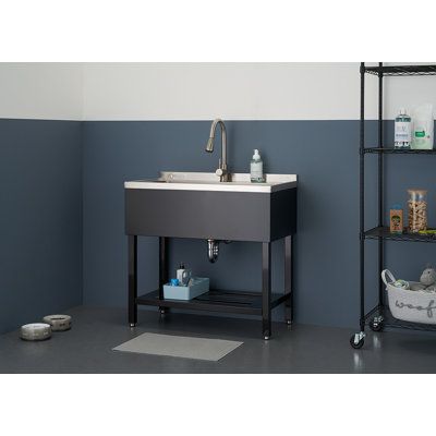 Trinity's NSF, UPC, and cups certified, 16-gauge 304 stainless steel utility sink with pull-out faucet was made with bigger jobs in mind. The oversized 30x14x11.5 basin is ideal for larger spaces and items and even for washing or grooming a small to medium-sized pet. The stainless steel pull-out faucet makes rinsing a breeze, while the matte black undershelf feature allows for the convenience of extra storage space. Mounting hardware, drain assembly, and adjustable feet levelers included. Total Laundry Room Utility Sink, Stainless Steel Utility Sink, Garage Laundry Rooms, Utility Sinks, Free Standing Sink, Outdoor Sinks, Pull Out Faucet, Laundry Tubs, Laundry Room Inspiration