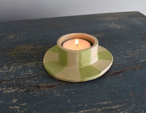 A hand sculpted ceramic tea light candle holder with a aqua blue interior and a candy green striped exterior. Pottery Votive Candle Holders, Handbuilt Candle Holders, Diy Tea Candle Holders, Ceramic Tea Candle Holders, Tea Light Ceramic, Clay Tea Candle Holders, Tea Light Holder Clay, Hand Sculpted Pottery, Diy Tealight Candle Holders