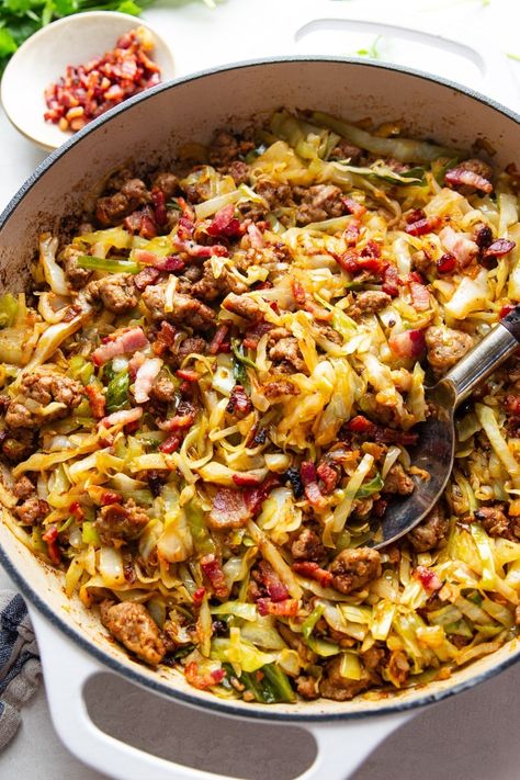 This recipe for Fried Cabbage With Sausage is so simple yet so delicious. Tender chunks of Italian sausage sauteed with onions and fresh cabbage topped with salty bacon bits make this one-pot meal ideal for a busy weeknight. Cabbage With Sausage, Fried Cabbage With Sausage, Low Carb Vegetable Soup, Sausage And Cabbage, Fried Cabbage Recipes, Kielbasa And Cabbage, Bacon Fried Cabbage, Oxtail Recipes, Cabbage And Sausage