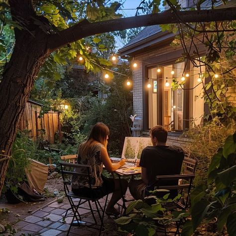 Couple having a romantic dinner in a garden at twilight, illuminated by string lights, surrounded by lush greenery. Perfect setting for a summer evening date. Outdoor Dinner Date, Romantic Outdoor Dinner, Twilight Garden, Outdoor Dinner, Date Dinner, Dinner Date, Summer Evening, A Romantic, String Lights