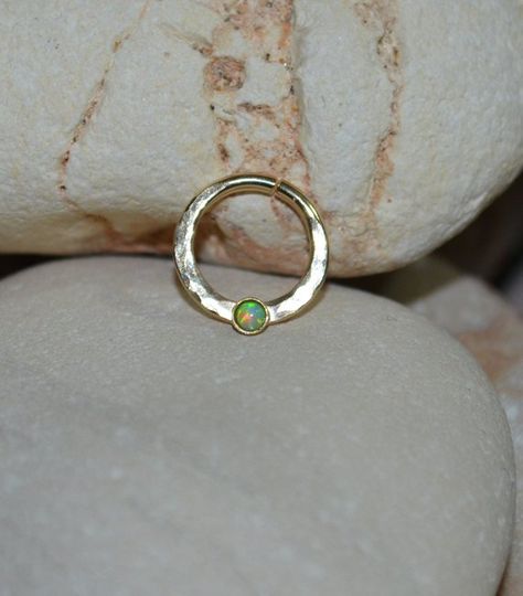 ⋙ 14kt Gold Filled kiwi green opal septum ring. ⋙ This listing is for one earring. ⋙ This ring is made of 16 gauge wire. ⋙ Available interior (inner) diameters: 8mm; 9mm; 10mm; 11mm; 12mm ⋙ Available gemstones: ruby; lapis lazuli; black onyx; emerald; light blue opal; garnet; white opal; kiwi green opal; amethyst; aqua blue cz; clear cz; black-red opal; turquoise; blue sapphire ⋙ Measurements: ⋙ The stone is 2mm in diameter ⋙  ⋙ I will put your order into a beautiful jewelry box (it will be read