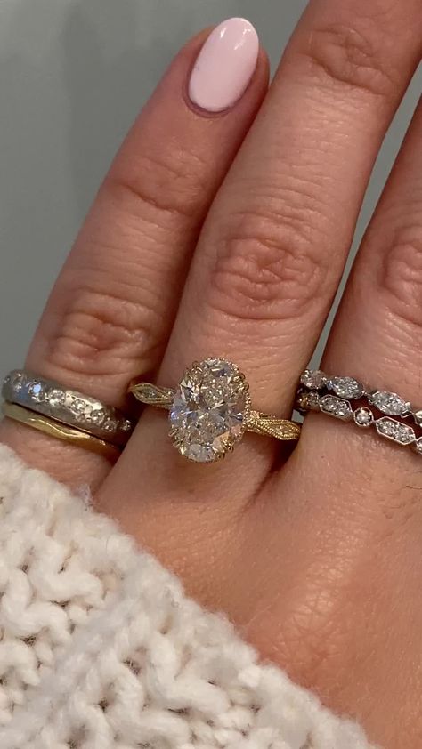 Odele showcases an intricate vintage inspired design that runs all the way around the band with white diamonds set within the features of the band. This desired design is the perfect combination of vintage chic and glamour. We then sprinkled some diamonds around the center stone for extra sparkle and a peek-a-boo halo. Approx Band Width (mm): 2.30mm Setting Diamond Quality (side stones): Colorless and VS clarity Approx Setting Total Carat Weight (side stones): 0.633 tcw Approx Production Time: 5 White Gold And Gold Rings Together, Love Knot Engagement Rings, Vintage Gold Oval Engagement Ring, Gold Ring Sets Wedding, Oval Vintage Ring, Gold Banded Engagement Rings, Spiral Rings Diamond, Vintage Inspired Engagement Rings Oval, Unique Ring Bands