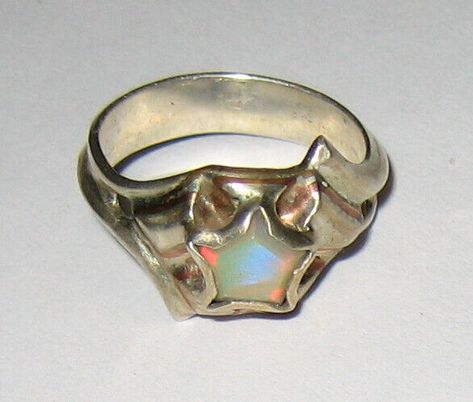 NATURAL SOLID AUSTRALIAN OPAL (HYDROPHANE CRYSTAL) IN STERLING SILVER RING WITH BRASS AND COPPER DETAILS   RING DETAIL INSPIRED BY WONDER WOMAN SIZE ~ 6.5 SETTING height ~ 5mm BAND width ~ 4.3mm STONE DETAIL SIZE ~ 7mm PENTAGON NATURAL SOLID AUSTRALIAN CRYSTAL OPAL  THIS ONE OF A KIND (NEVER CAST) SILVER RING HAS A LOW PROFILE DESIGN TO PREVENT CATCHNG AND SNAGGING. INSPIRED BY WONDER WOMAN MADE WITH THE "PERSON ON THE GO" IN MIND. WE BELIEVE YOU DON'T HAVE TO SACRAFICE FUNCTION FOR FASSION SO LET US OFFER YOU BOTH.  CLASSY AND HAND CRAFTED IN THE USA  (BY E.N. OF META STONE DESIGN) COMBINED SHIPPING IS ALWAYS WELCOME AND YOU CAN SHOP WITH US FOR UP TO 21 DAYS ON ONE INVOICE!   STANDARD SHIPPING STRUCTURE FOR ALL LISTINGS: ------------------------------------ USA ~ STORE LISTINGS: FREE SHI Galaxy Jewelry Rings, Opal Star Ring, Stone Setting Jewelry Design, Resin And Metal Jewelry, Raw Silver Jewelry, Soldered Metal Jewelry, Weird Wedding Rings, Silver Clay Ring, Soft Solder Jewelry