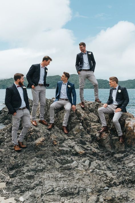 Groomsmen in Grey Chinos & Navy Blazers | Outdoor Coastal Wedding at Ohawini Bay in New Zealand with Natural Garden Party Reception | Miss Gen Photography Outdoor Groomsmen Attire, Groomsman Beach Wedding Attire, Garden Party Reception, Beach Wedding Navy, Coastal Weddings, Wedding Groomsmen Attire, Navy Blazers, Simple Beach Wedding, Grooms Party