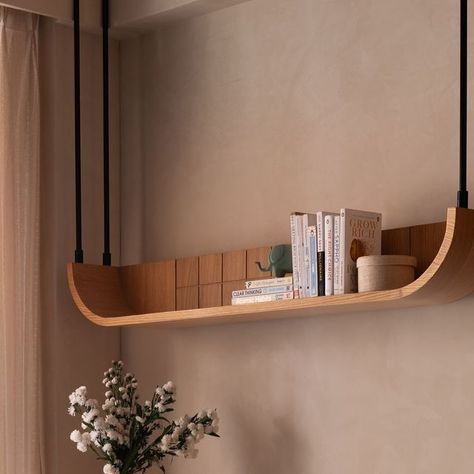 Studio Ipsa | Interior Design Studio on Instagram: "When reading desks are a requirement, we work a charm like this 😍  Just like the rest of the room, we kept the table minimal yet added bespoke legs that make a statement ❤️   Aligning the base to the curves used throughout the home, we created this masterpiece.   A ceiling hung shelf completes the set up in perfect usability and aesthetics 🥰 . Photo credit: @nayansoni21  . . #studioipsa #workstation #studydesk #interiordesign #interiordesignideas #texturepaint #interiordesigninspiration #interiorinspiration" Study Table Shelf Ideas, Curved Shelf Design, Shelf Designs For Bedroom, Interior Shelf Design, Curved Furniture Interior Design, Complete Home Interior Design, Working Desk Design, Curved Wall Decor Ideas, Minimal Office Interior