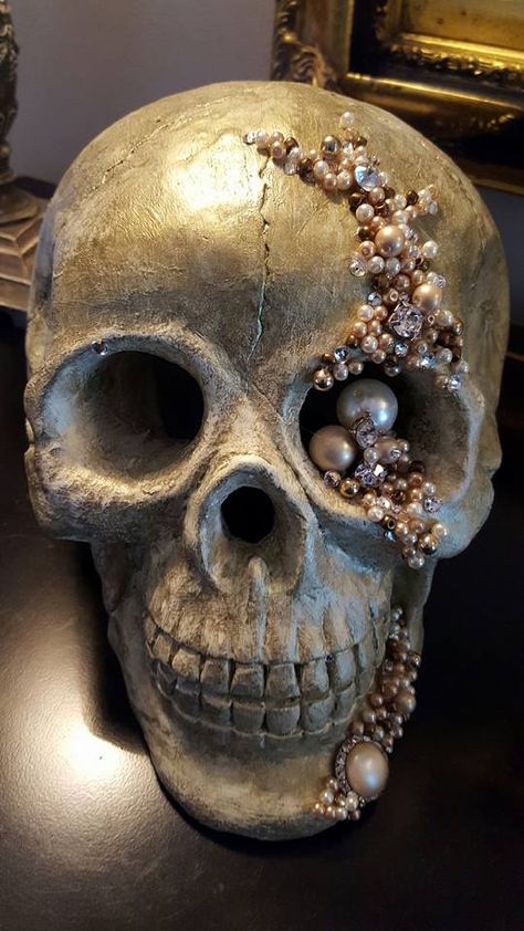 Glamorous Halloween Decorations. For my Pearl and Jeweled Skull I painted ceramic skull  off white with bronze rubbed glaze. Used broken jewelry I had to create this with E6000 to secure it. Fun project that didn't take long! Glam Halloween! Jeweled Skulls Diy, Bejeweled Skull Diy, Rhinestone Skull Decor, Jeweled Skull Diy, Glam Skull Decor, Bedazzled Skull Head, Skull Decor Halloween, Decorated Skulls Halloween, Painted Skulls Halloween