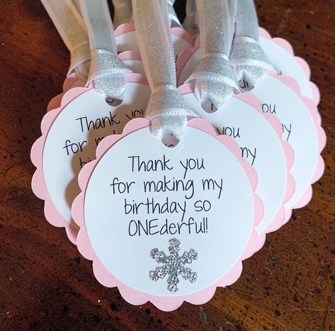 "These party favor tags will look gorgeous on your party favors at your little one's Winter ONEderland themed birthday.  Each tag is 2.2 inches in diameter.  The tags will come with the ribbon as shown in the pics. The ribbon is white with silver glitter.  This listing is for pink and silver party favor tags.  Coordinating Decorations https://www.etsy.com/shop/declanandsmith?ref=seller-platform-mcnav&section_id=18436403 Receive 10% off your purchase when you sign up for our weekly newsletter. ww Winter Onederland Birthday Party Favors, Winter Onederland Party Activities, Winter Onederland Activities, Winter Wonderland Theme Birthday Party, Diy Winter Onederland Decorations, Winter Wonderland Party Favors, Winter Onederland Centerpieces, Winter Onederland Party Food, Winter First Birthday Themes