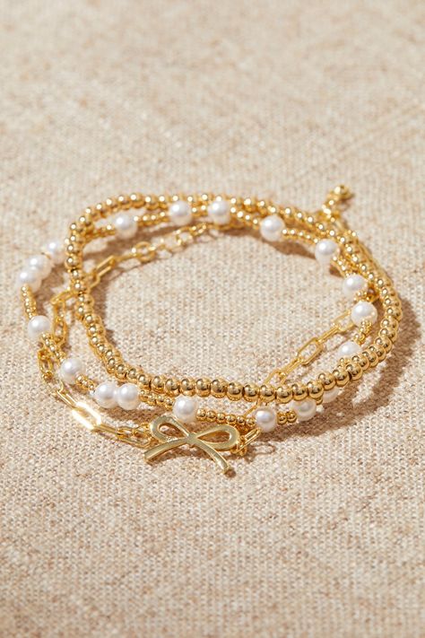 18K Gold Beaded Bow Bracelet Pack in Gold | Altar'd State Mini Beaded Bracelets, Gold Stack Bracelets, Aesthetic Friendship Bracelets, Sorority Bracelets, Bracelet Stack Gold, Pearl Gold Bracelet, Braclets Gold, Jewelry Gold Bracelet, Gold Bracelets Stacked