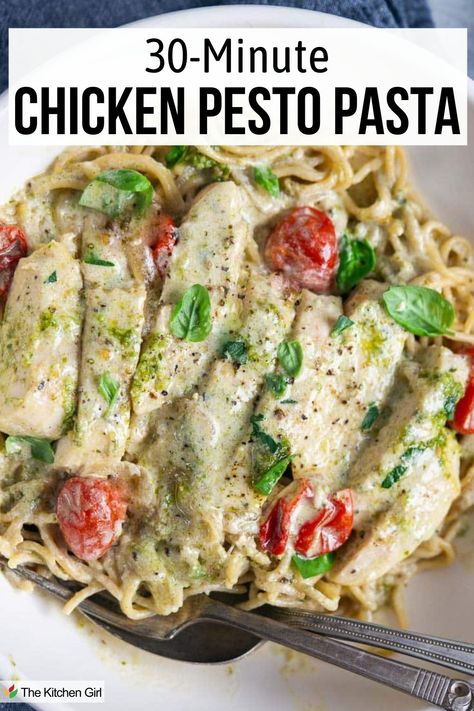 Creamy chicken pesto pasta in white bowl with fork and spoon. Title: 30 minute chicken pesto pasta. Chicken With Pesto Pasta, Pesto And Chicken Pasta, Crockpot Pesto Chicken Pasta, White Pesto Pasta, Lemon Pesto Chicken Pasta, Chicken Pesto Pasta Recipes Easy, Chicken Pesto Pasta Recipes, Chicken Tomato Pesto, Pesto Dinner Recipes