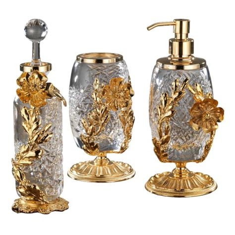 Lavish and fancy, this bathroom set featuring a soap dispenser, a toothbrush holder, and a perfume bottle is achieved as a result of painstaking artisan work. Dipped in 24K, the metal components are crafted of bronze with the lost-wax casting method and complement precious bodies in mouth-blown transparent crystal incorporating 24% lead and boasting minute, handmade etchings. Each piece can be purchased separately. Please ask the Concierge for color variants and etching customizations.