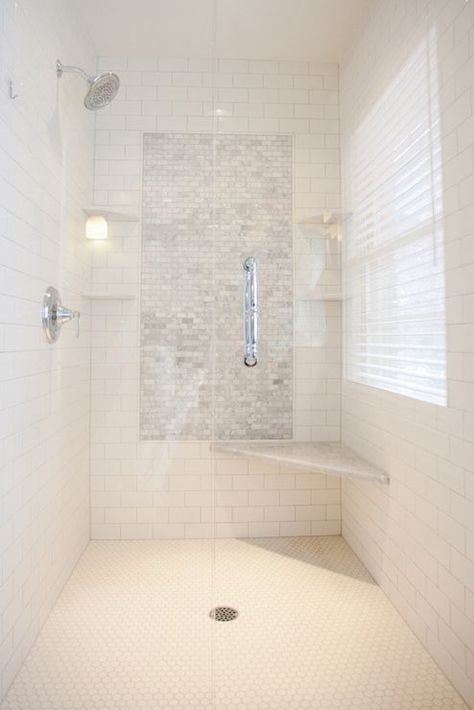 Stunning walk-in shower with a subway tiled interior and mini marble brick tiled accent panel flanked by corner shelves with rainfall shower head to the left and marble corner seat to the right over white mini hex tiled floors. Corner Shower Seat, Shower Accent Tile, Shower Corner Shelf, Window Seating, Tiled Bathroom, Bathroom Blinds, Bilik Air, Corner Window, Shower Seat